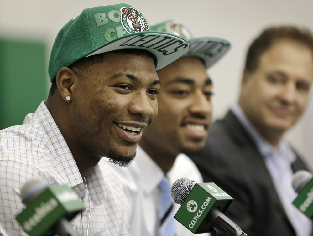 Marcus Smart, left, of Oklahoma State and James Young, center, of Kentucky were selected Thursday in the first round of the NBA draft by the Boston Celtics.