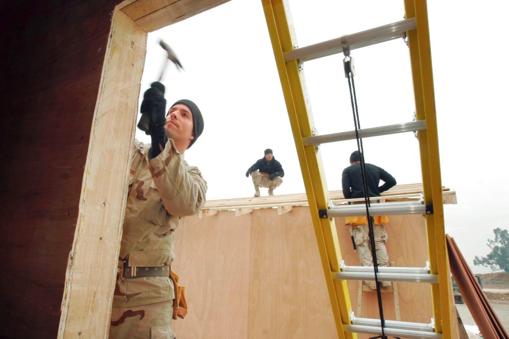 In this 2004 file photo, Sgt. Todd Kiilsgaard of Westbrook hammers as part of the 133rd Engineer Battalion.