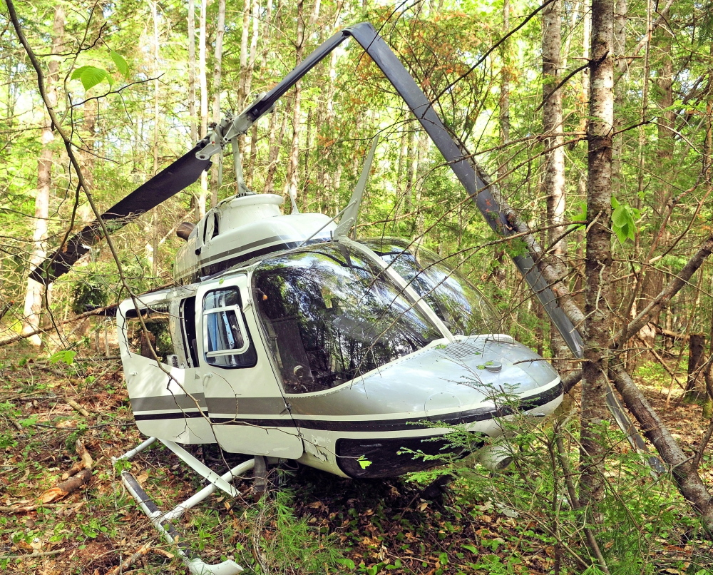 The helicopter crashed Friday in a heavily wooded area off East River Road in Whitefield. Maine Helicopters Inc., which owns the aircraft, is about a mile away to the south. Staff file photo by Joe Phelan