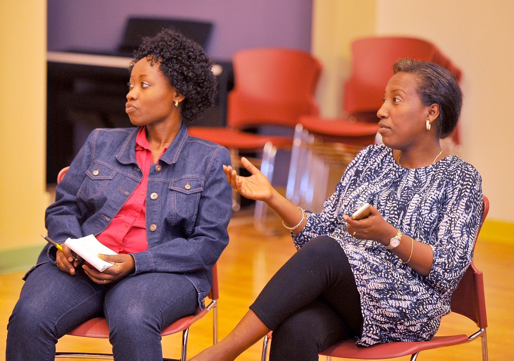 Ridelphine Katabesha, left, who immigrated from the Democratic Republic of the Congo, listens as Mia Ntahobari from Burundi communicates with other members of a women's group meeting. They both expressed their concern for their family, friends and the immigrant community with Gov. LePage's edict to withhold funding for General Assistance for  undocumented immigrants.