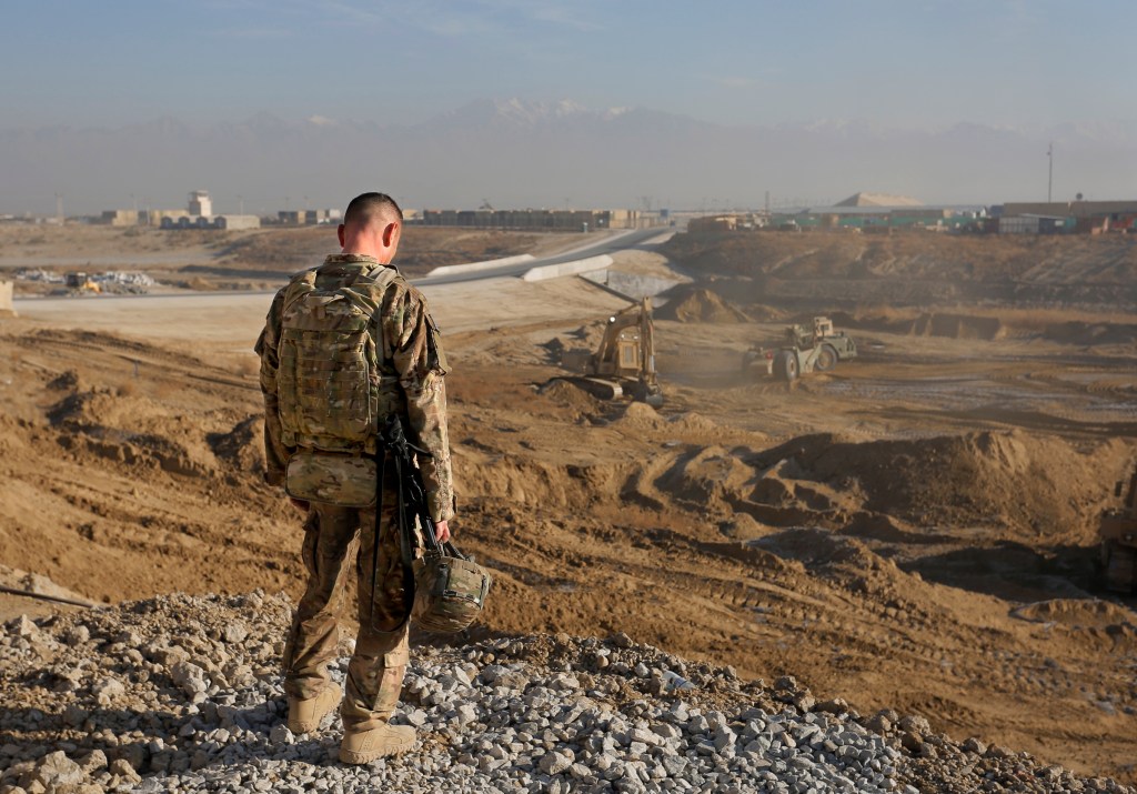 In this December 2013 file photo, Staff Sgt. Jonathan Boubel of Durham takes a moment to himself as he stands at the edge of an old minefield at Bagram Airfield in Afghanistan. The 133rd Engineer Battalion has returned from Afghanistan to the United States.