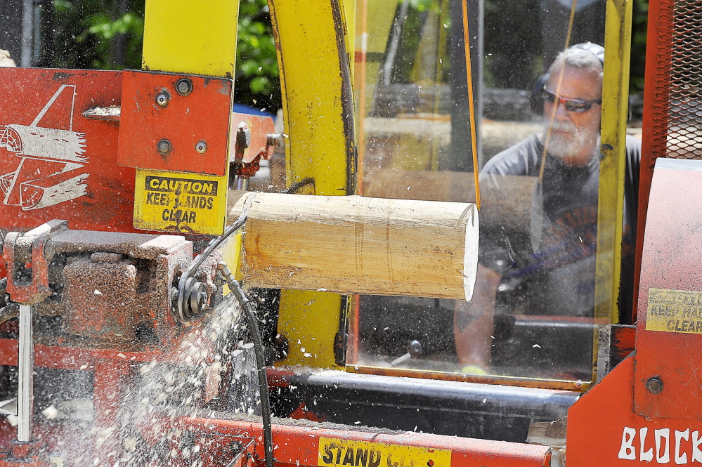 WINDHAM, ME - MAY 21: Mark Killinger, owner of Atlantic Firewood cuts the hardwood logs into smaller sized firewood for sale. (Gordon Chibroski/Staff Photographer)