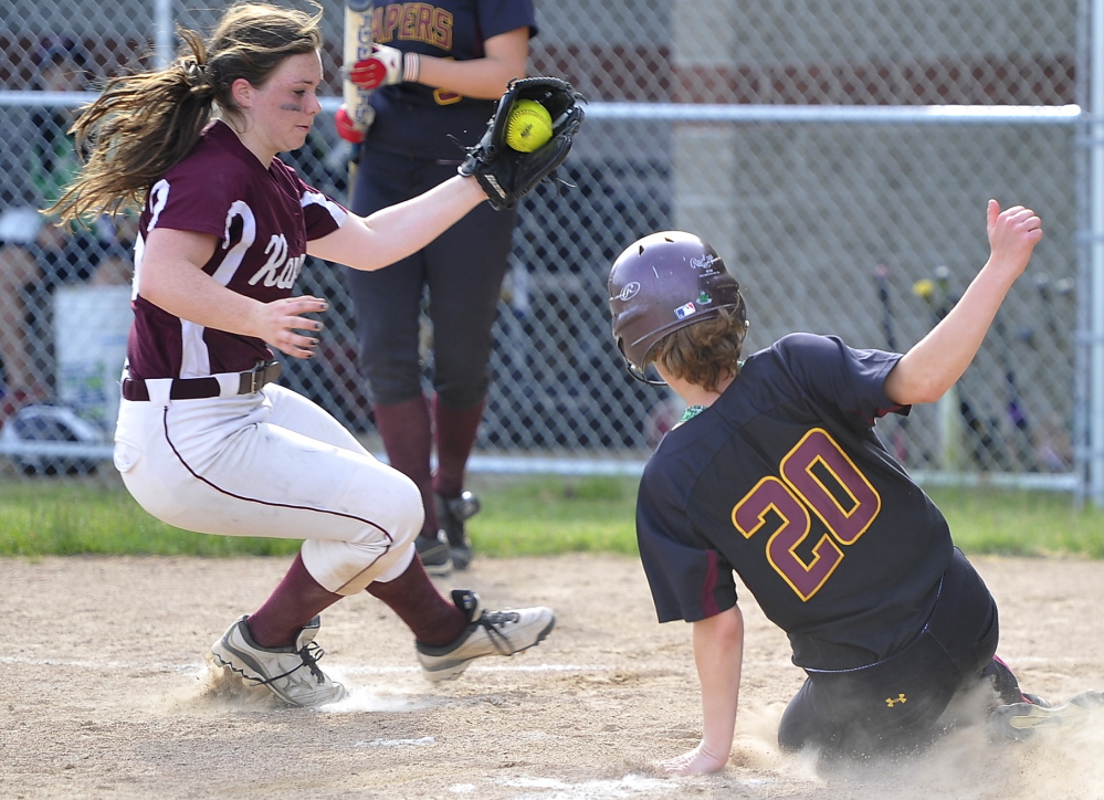 Greely pitcher Miranda Moore takes the throw from the catcher after a passed ball, allowing Sam Feenstra of Cape Elizabeth to score in Mondayâs softball game at Cape Elizabeth. Cape won, 10-6. Gordon Chibroski/Staff Photographer