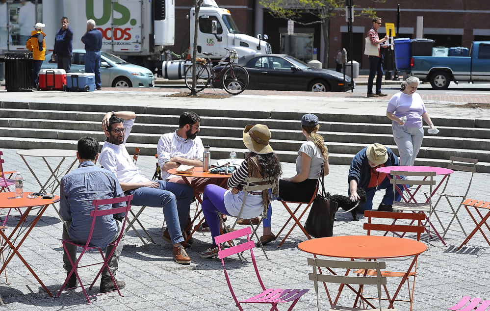 PORTLAND, ME - MAY 29: Day in the life of Congress Square Plaza. Visitors enjoy tables and chairs provided by the Friends of Congress Square Plaza under an agreement with the city. (Photo by Gordon Chibroski/Staff Photographer)