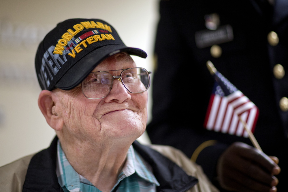 World War II veteran Sherwin Callander, 94, talks to the media Monday after his naturalization ceremony in Atlanta. He is headed to France for D-Day ceremonies. The Associated Press