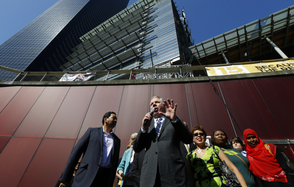 The Associated Press/Ted S. Warren Seattle Mayor Ed Murray, center speaks Monday, June 2, 2014, at a rally outside Seattle City Hall after the Seattle City Council passed a $15 minimum wage measure in Seattle.