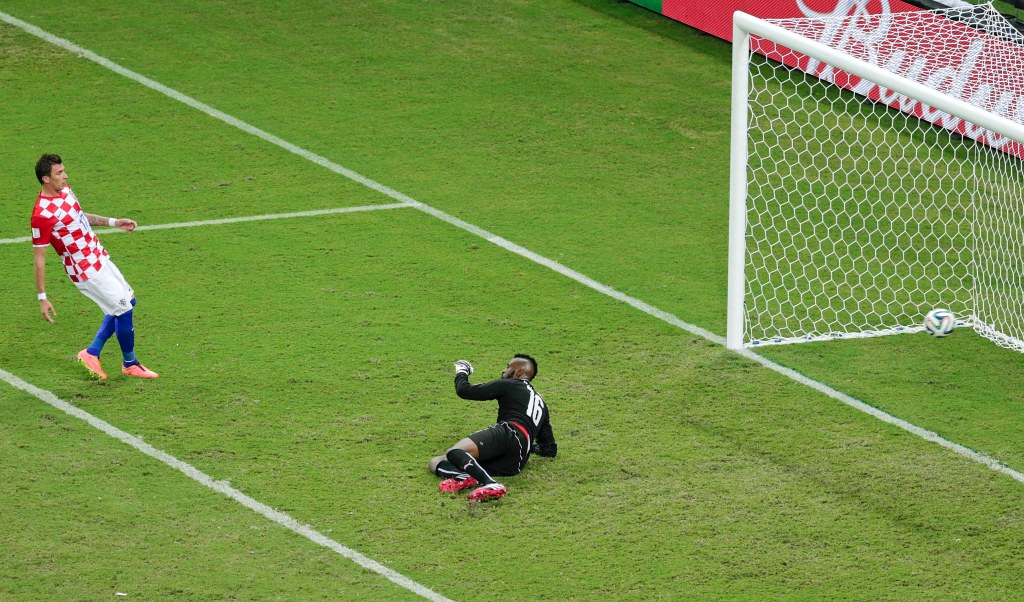 Croatia's Mario Mandzukic scores his side's fourth goal past Cameroon's goalkeeper Charles Itandje, right.