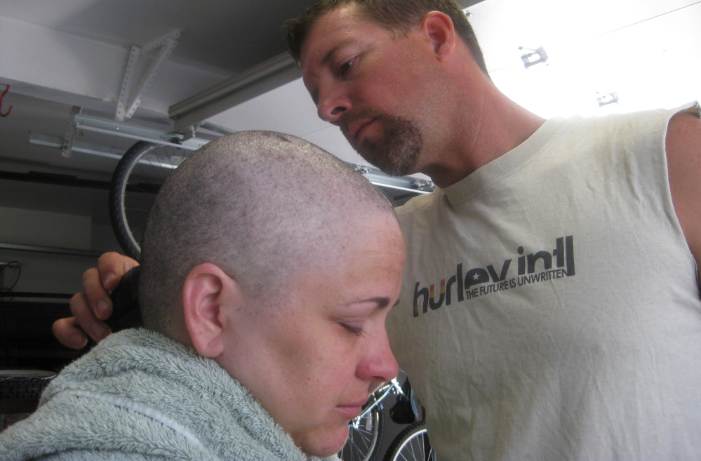 Arrica Wallace has her head shaved by her husband, Matthew, in August 2012 in Manhattan, Kan. Arrica Wallaceâs cervical cancer did not respond to chemotherapy but she has completely clean scans after undergoing experimental immunotherapy. The Associated Press