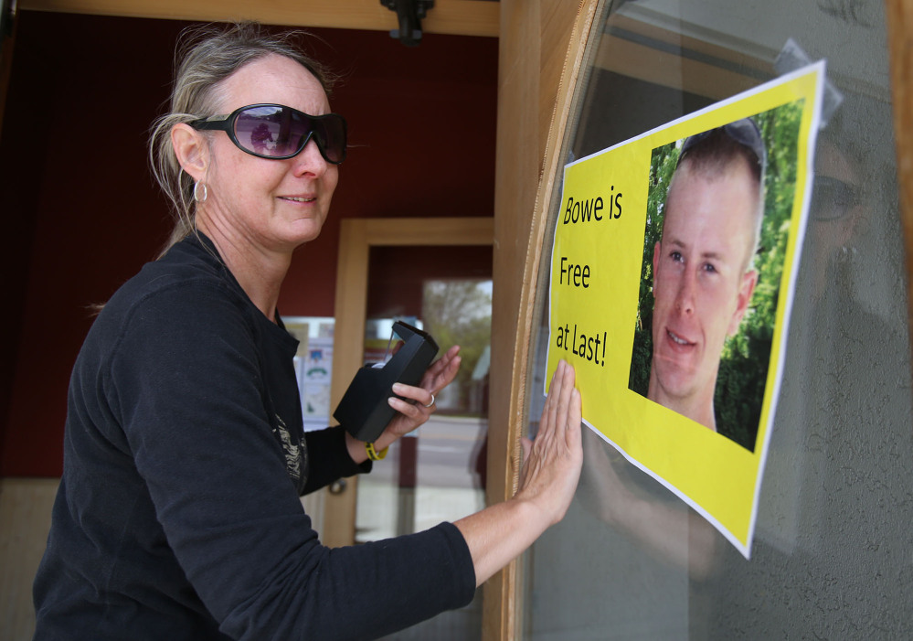 Sondra Van Ert, co-owner of Baldy Sports, hangs a sign celebrating news of U.S. Army Sgt. Bowe Bergdahlâs release on Saturday in Hailey, Idaho, his hometown. Bergdahl, 28, had been held prisoner by the Taliban since June 30, 2009. The Associated Press