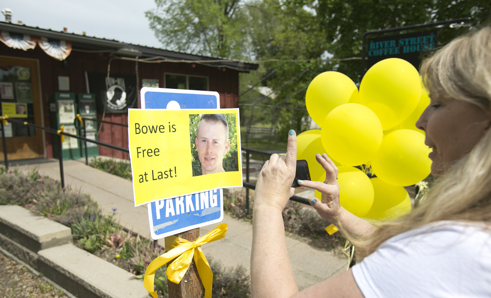 Diane Walker takes a picture of a sign celebrating U.S. Army Sgt. Bowe Bergdahlâs release in front of Zaneyâs coffee shop in Hailey, Idaho. The Associated Press