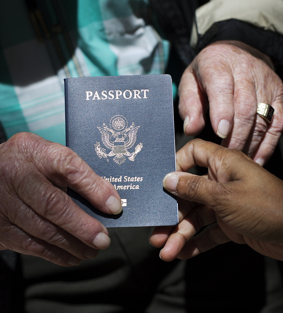 Sherwin Callander is handed his first-ever U.S. passport at the ceremony in Atlanta on Monday. He hasnât been back to France since 1944. The Associated Press