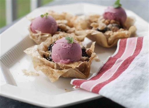 Mini cherry phyllo pies with frozen yogurt. Matthew Mead/The Associated Press