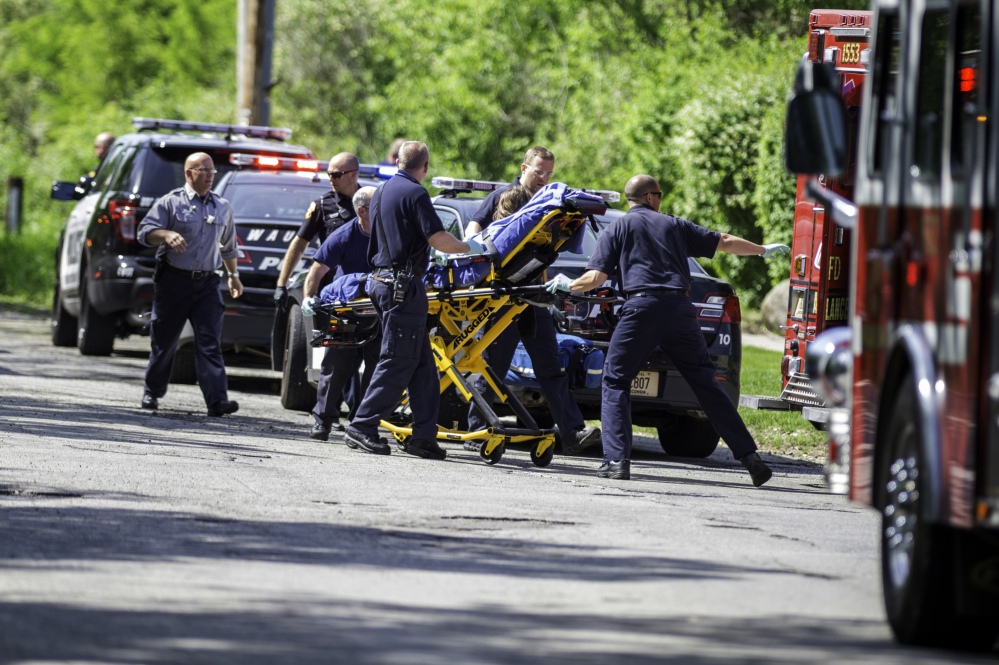The Associated Press Rescue workers take a stabbing victim to an ambulance in Waukesha, Wis., on Saturday. Two 12-year-old girls are charged in the attack.