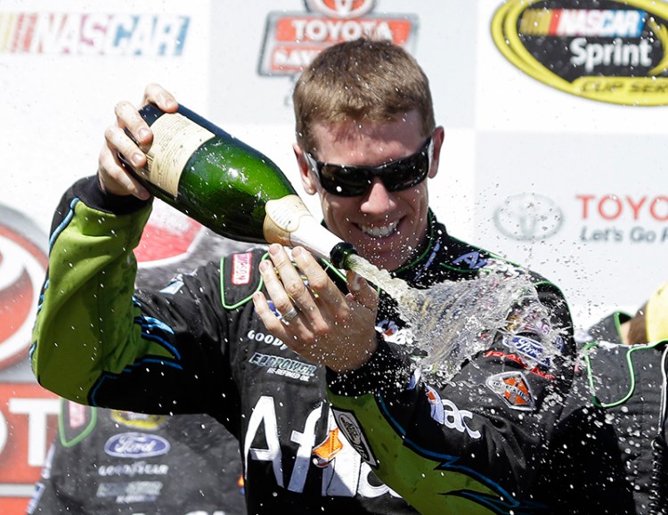 Carl Edwards sprays sparkling wine after winning the NASCAR Sprint Cup Series auto race Sunday, in Sonoma, Calif. Edwards won the race and Jeff Gordon finished second. The Associated Press