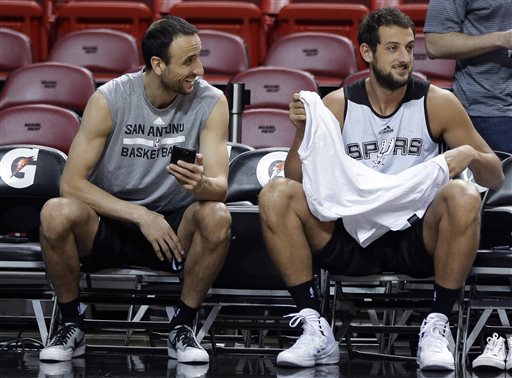 San Antonio Spurs' Manu Ginobili, left, laughs with Marco Belinelli, right, during NBA Finals basketball practice Wednesday in Miami. The Spurs lead the Miami Heat two games to one in the best of seven series. The Associated Press
