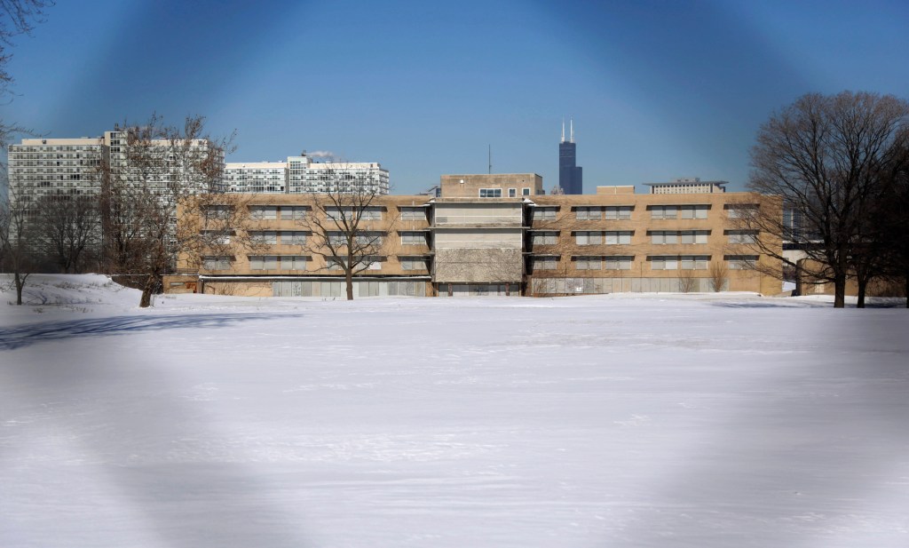 This Feb. 7, 2014,  photo, shows a view  through a fence of the campus that once housed  Michael Reese Hospital in the South Side neighborhood of Bronzeville in Chicago. The site in the city's historic center of black culture, business and politics, is bidding to be the location for a Barack Obama presidential library. 