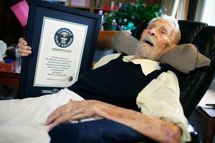 111-year-old Alexander Imich holds a Guinness World Records certificate recognizing him as the world's oldest living man during an interview with Reuters at his home on New York City's upper west side, May 9, 2014. REUTERS