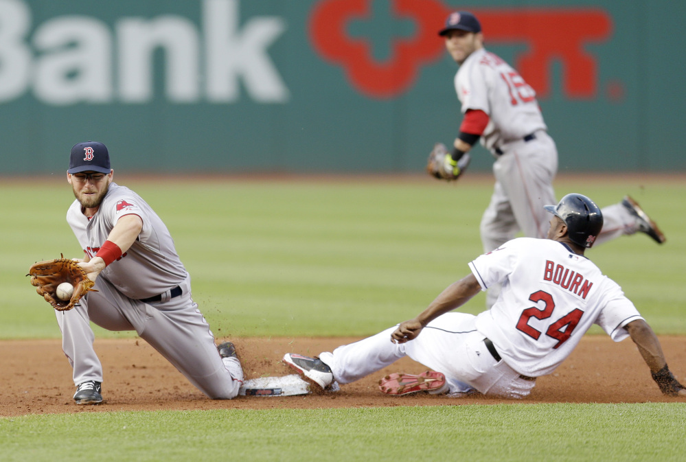 Cleveland Indians' Michael Bourn, right,  steals to second base as Boston Red Sox's Stephen Drew, left, waits for the throw in the first inning of a baseball game, Monday, June 2, 2014, in Cleveland. Bourn was safe on the steal. (AP Photo/Tony Dejak)