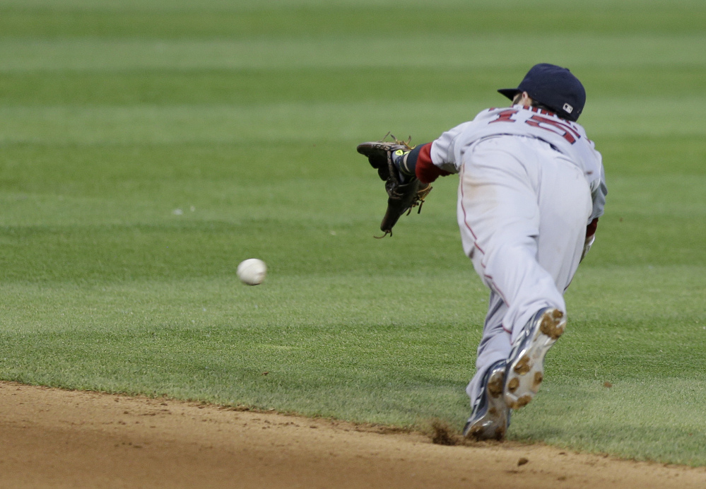 Boston Red Sox's Dustin Pedroia dives but can't get to a single hit by Cleveland Indians' David Murphy in the inning of a baseball game, Monday, June 2, 2014, in Cleveland. The Indians defeated the Red Sox 3-2. (AP Photo/Tony Dejak)