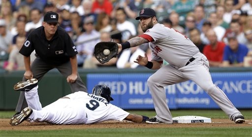 Red Sox first baseman Mike Napoli, right, catches the ball on a pick-off attempt as Seattle's Endy Chavez dives safely back to first base Tuesday in Seattle. The Associated Press