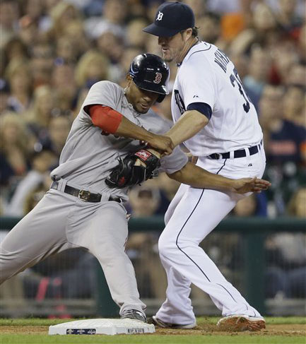 Red Sox third baseman Xander Bogaerts beats the tag of Tigers relief pitcher Joe Nathan as he steals third in  the ninth inning Saturday in Detroit. The Associated Press