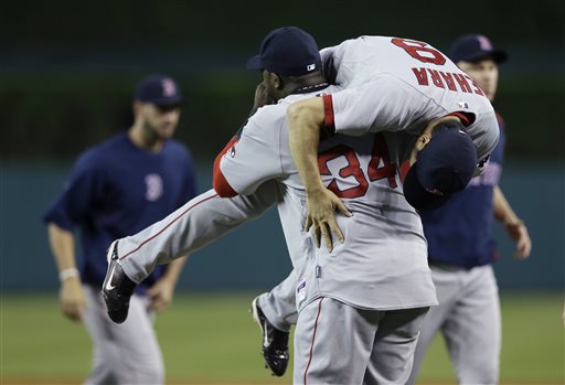 Boston Red Sox designated hitter David Ortiz lifts relief pitcher Koji Uehara after the ninth inning against the Detroit Tigers in Detroit on Sunday. The Associated Press