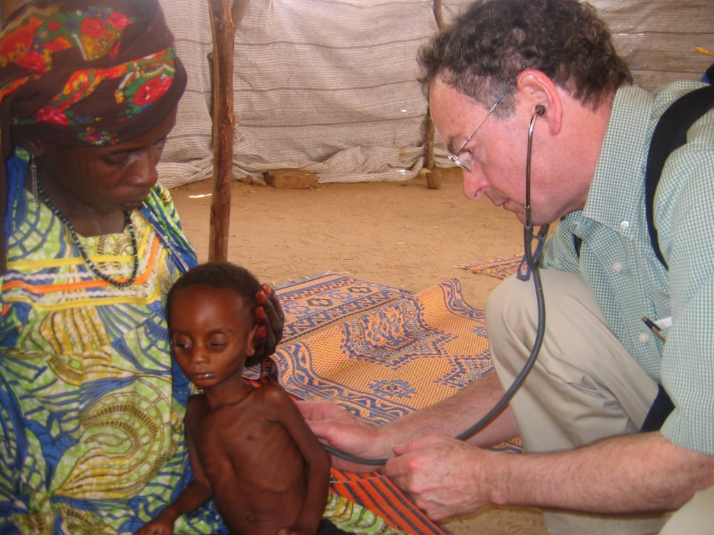 Dr. Richard Rockefeller examines a patient in Nigeria in 2009.