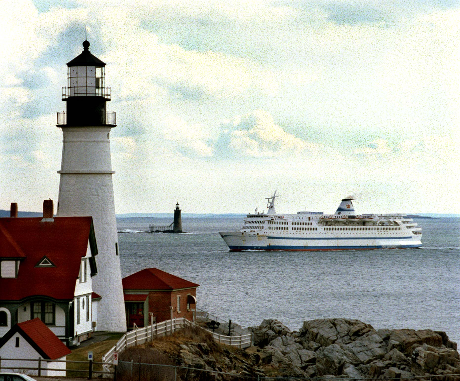 The Scotia Prince returns to Portland for the summer season on April 8, 1997. In the foreground is Portland Head light and Ram Is. light is in the background.