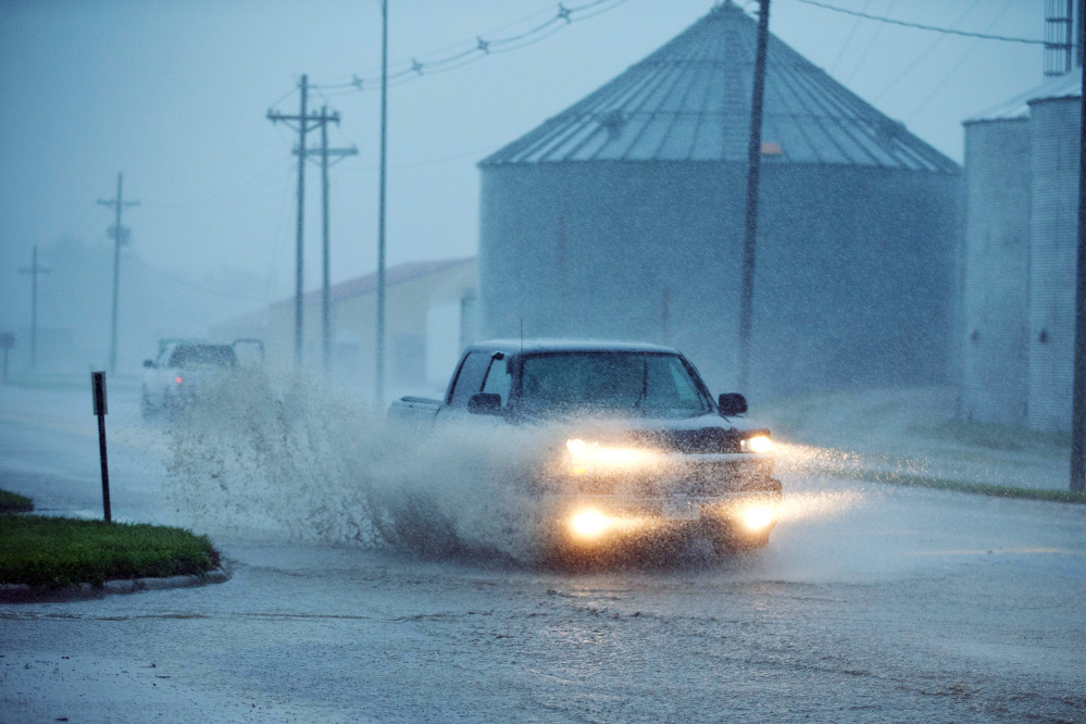 The Associated Press A truck drives through high water in Arlington, Neb., Tuedsay.