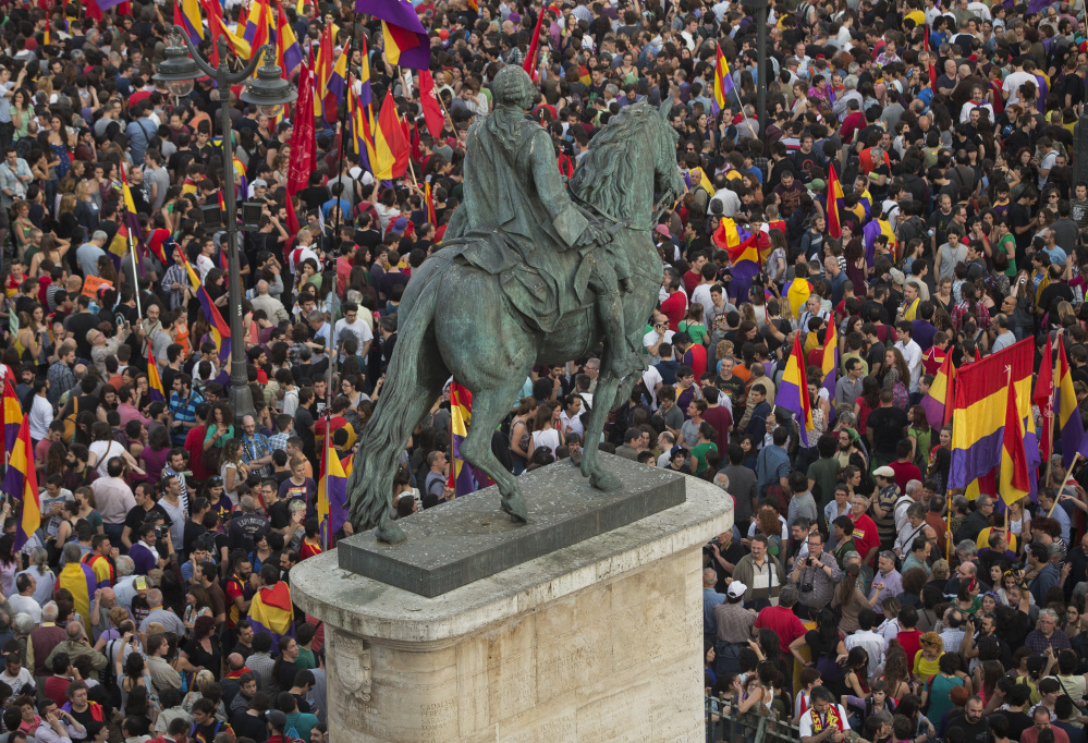Crowds of people gather and wave republican flags around the monument of Charles III, King of Spain, in the main square of Madrid on Monday after the announcement of the planned abdication of Spainâs King Juan Carlos. The Associated Press