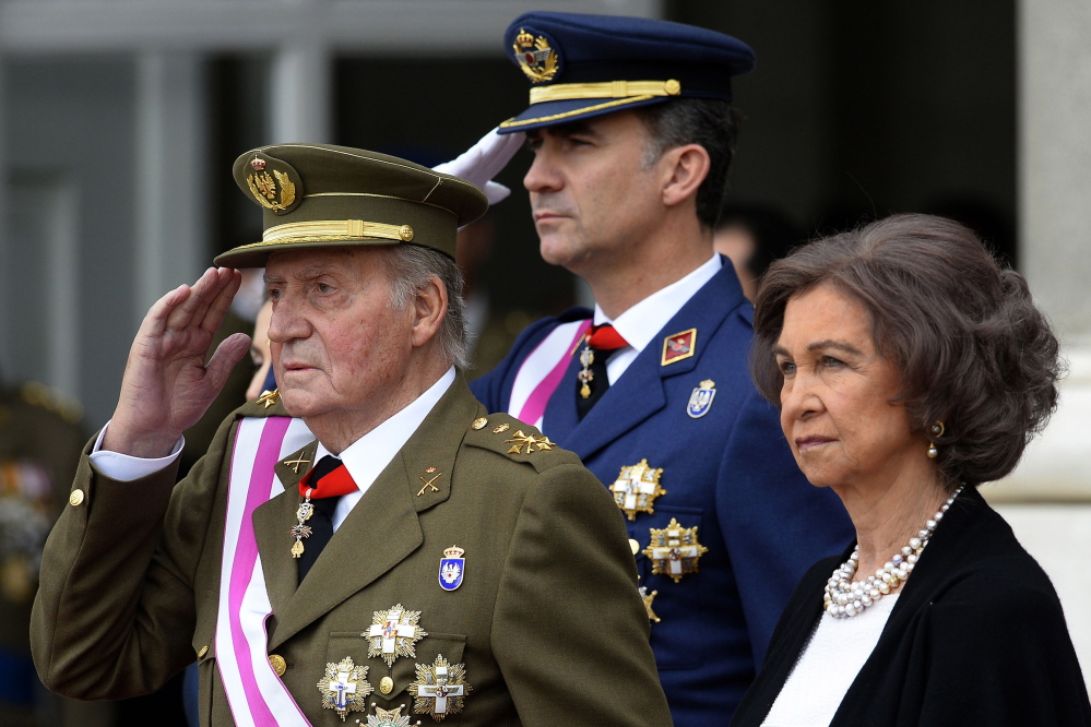 In this Jan. 6, 2014, file photo, Spainâs Crown Prince Felipe, center, Spainâs King Juan Carlos, left, and Spainâs Queen Sofia, right, attend the annual Pascua Militar Epiphany ceremony at the Royal Palace in Madrid. The Associated Press
