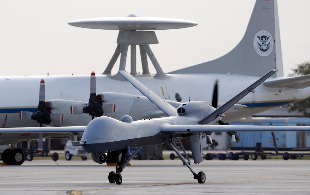 In this 2011photo, a Predator B unmanned aircraft taxis at the Naval Air Station in Corpus Christi, Texas. Missiles from U.S. drones slammed into militant hideouts overnight in northwestern Pakistan, killing more than a dozen  suspected insurgents