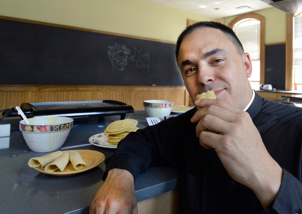 Father Paul Dumais makes ployes in a kitchen at St. Mary's Nutritional Center in Lewiston.
John Patriquin/Staff Photographer