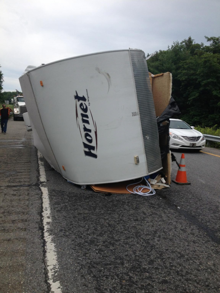 A truck and its trailer flipped on I-95 late Sunday morning, backing up southbound traffic for more than four hours. Photo courtesy of Maine State Police