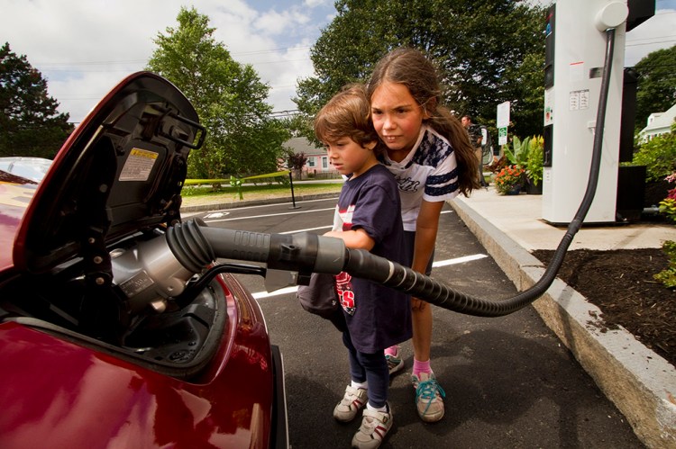 Luis Frederick Robinson, 4, and his sister Kerry-Elizabeth, 8, watch an electric car get quick-charged in South Portland. Carl D. Walsh/Staff Photographer