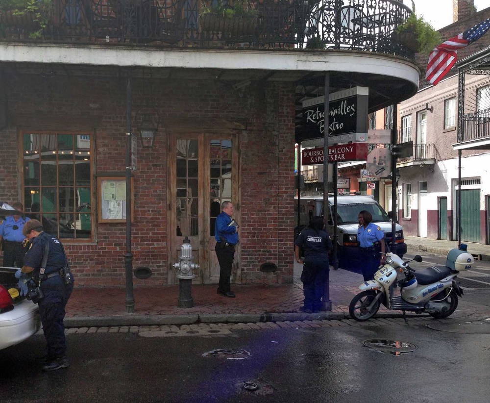 Authorities work the scene along Bourbon Street in New Orleans after a shooting early Sunday. Ten people were shot, with at least one person in critical condition.