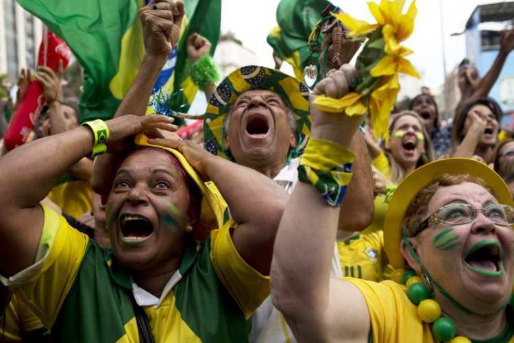 In this June 28, 2014 file photo, Brazil fans celebrate after their team scored a goal during a penalty shootout at the World Cup round of 16 soccer match between Brazil and Chile inside the FIFA Fan Fest in Sao Paulo, Brazil.