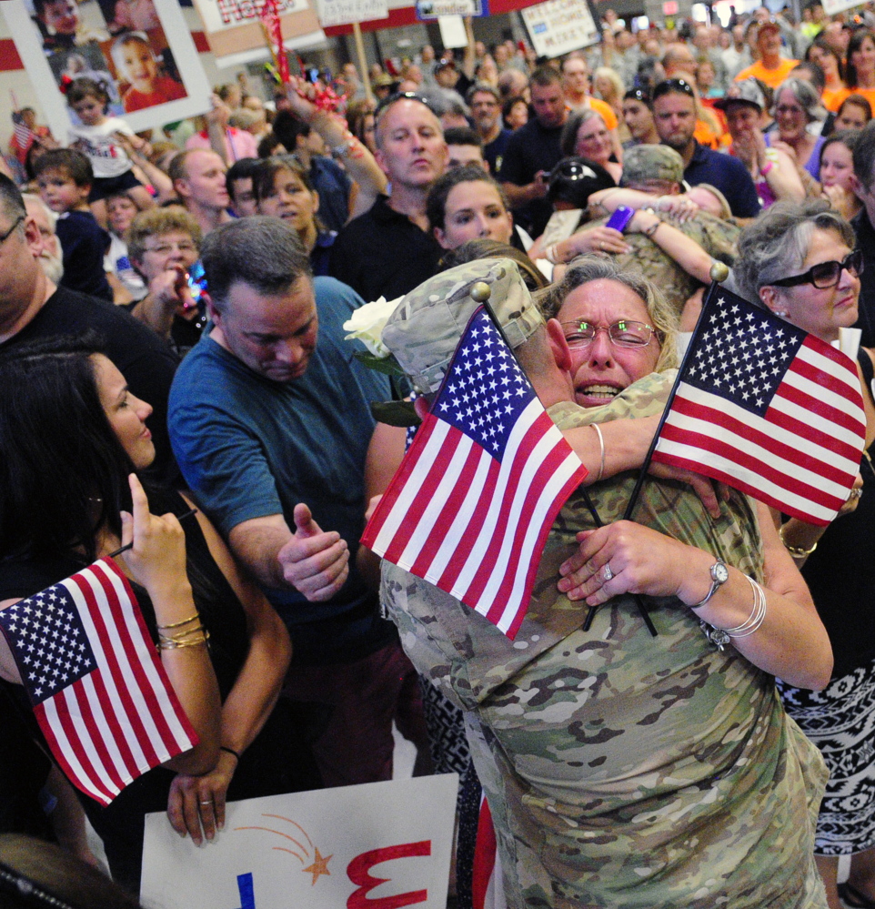 Hundreds of wives, husbands, parents, grandparents, children and others packed the sweltering Augusta Armory, breaking out in sustained applause as the soldiers filed in. When they were officially dismissed, there was a mad scramble, followed by hugs, kisses and tears.