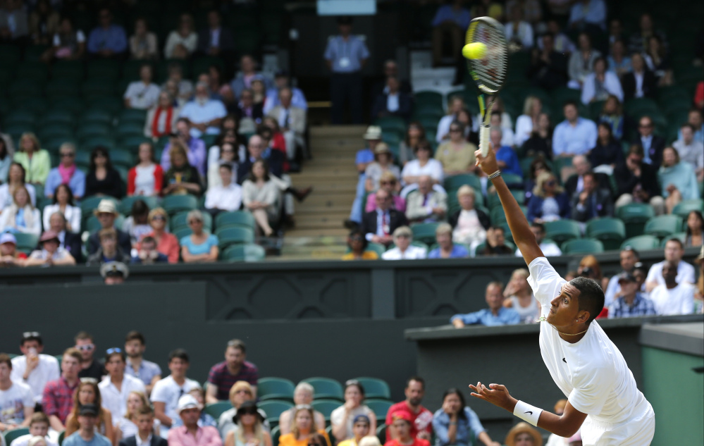 Nick Kyrgios of Australia serves to Rafael Nadal of Spain during their men’s singles match at the All England Lawn Tennis Championships in Wimbledon, London, Tuesday, July 1, 2014.