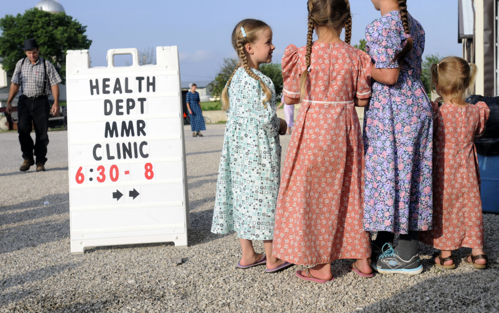 Mennonite girls gather at a clinic offering vaccinations against measles, mumps and rubella, in Shiloh, Ohio, last week. The religion of the Amish doesn’t prevent them from seeking vaccinations but because their children don’t attend public schools vaccinations aren’t routine.