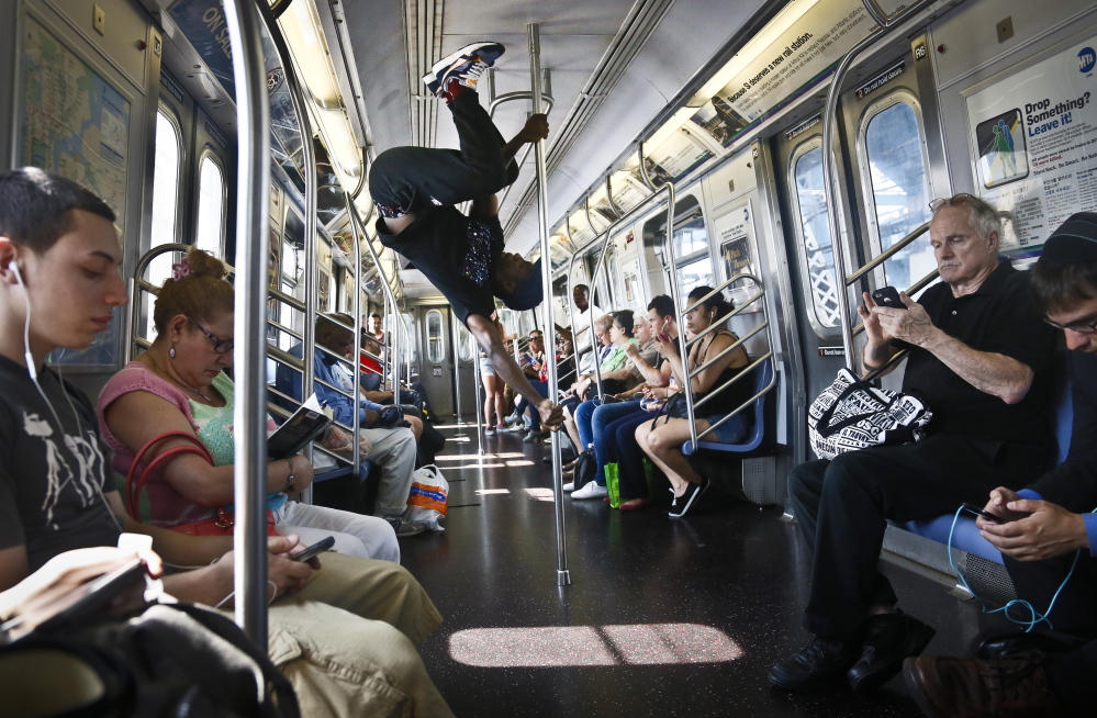 Subway security now pans the antics of Dashawn Martin, center, a member with the dance troupe W.A.F.F.L.E., which stands for We Are Family For Life Entertainment.