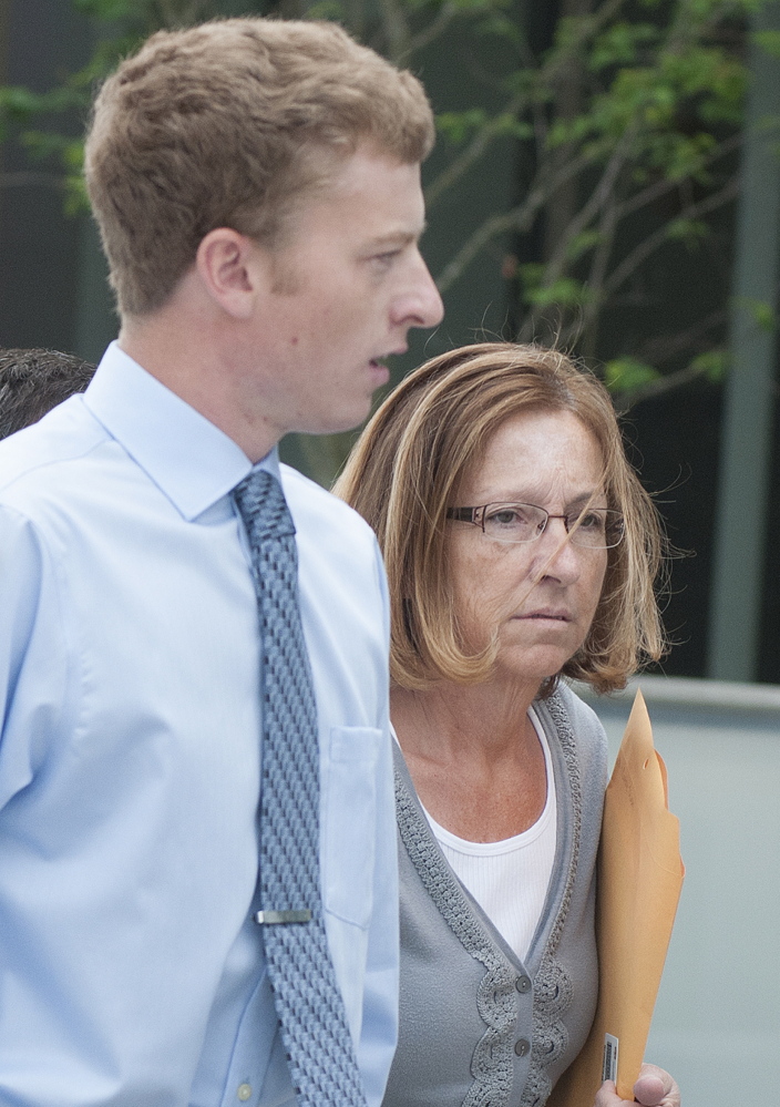 Carole Swan, former Chelsea selectwoman, with her younger son John Swan, as they enter the U.S. District Court building in Bangor June 13 for her sentencing hearing on extortion, tax fraud and workers compensation fraud.