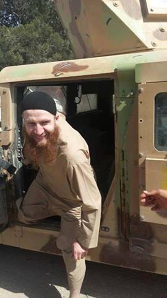 This undated image posted on a militant social media account, shows Omar al-Shishani climbing out of a humvee.