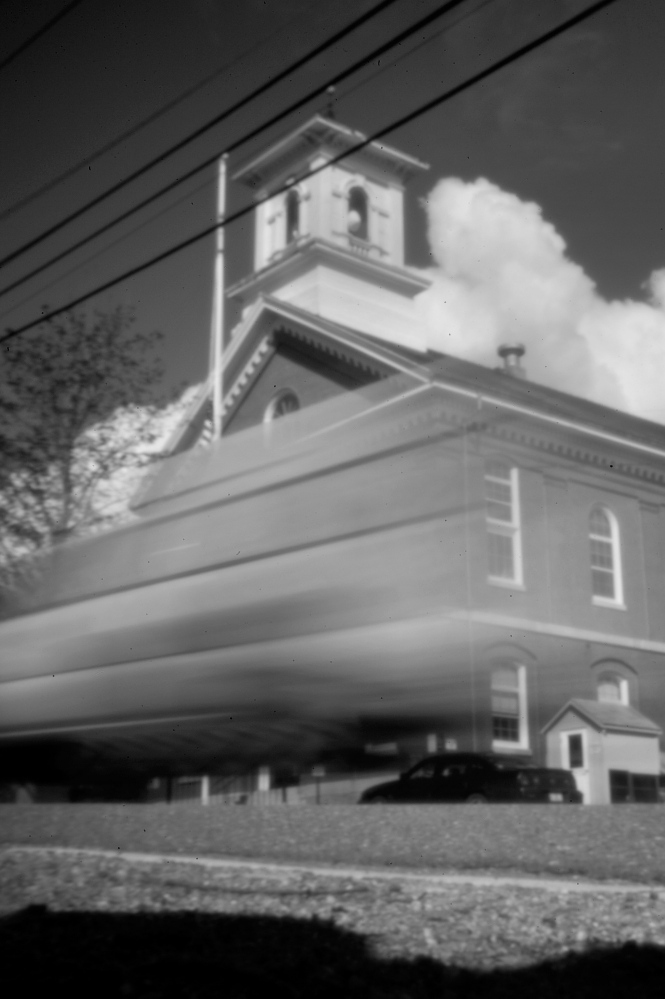 Captured in the aperture of a pinhole camera, a vehicle streaks past Washington County Courthouse in Machias recently. James Ellinwood, the only hunter in the group of five from Massachusetts to be charged in a violent altercation with the Passamaquoddy at Pleasant Point in 1965, was tried on a single count of manslaughter during his trial here. For Indians, the proceedings were a devastating experience.
