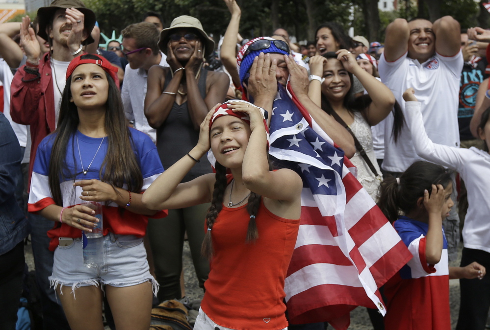 Amy Mazariegos, foreground, reacts with other United States fans as they watch the World Cup round of 16 soccer match between the United States and Belgium at a public viewing party in San Francisco, Tuesday, July 1, 2014.