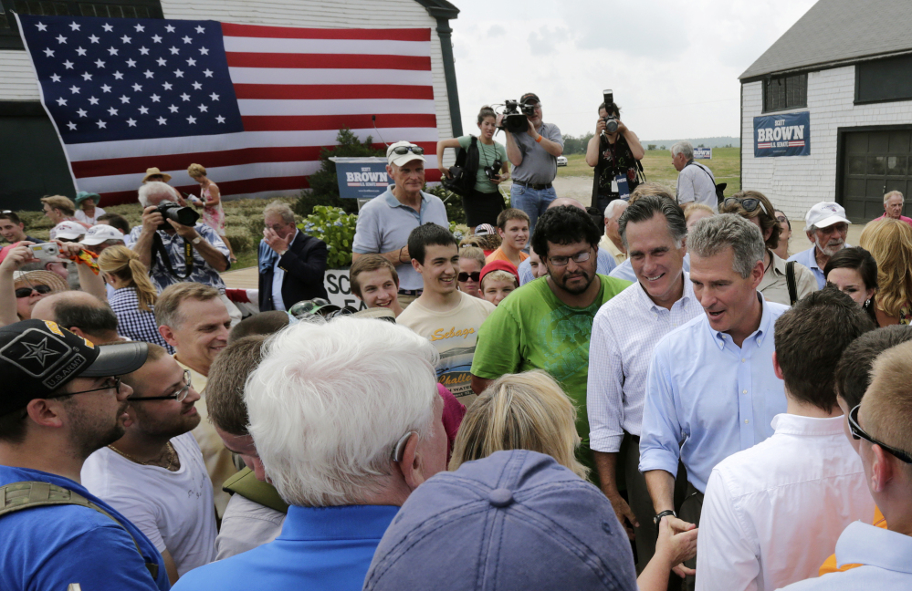Mitt Romney accompanies New Hampshire senate candidate Scott Brown during a campaign stop at a farm in Stratham, N.H. on Wednesday. Romney endorsed Brown at the event and said he had no interest in making a third run at the presidency.