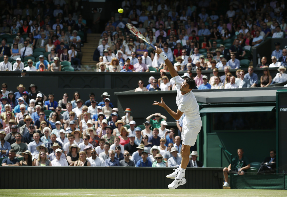 Grigor Dimitrov of Bulgaria serves to Andy Murray of Britain during their men’s singles quarterfinal match.