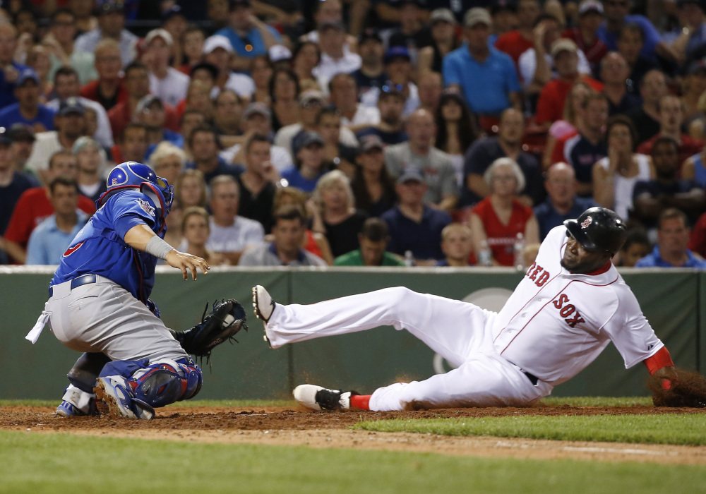 Cubs catcher Welington Castillo applies the tag as Red Sox designated hitter David Ortiz is out trying to score on a fielder’s choice grounder by Xander Bogaerts in the sixth inning.