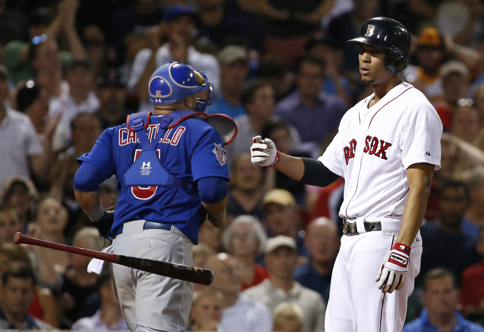Red Sox third baseman Xander Bogaerts tosses his bat after striking out with the bases loaded in the fourth inning against the Chicago Cubs at Fenway Park on Wednesday. Cubs catcher Welington Castillo is at left.