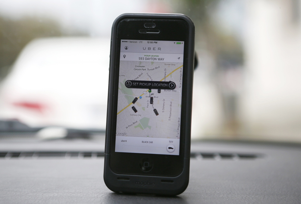 An Uber app is seen on an iPhone in Beverly Hills, California, December 19, 2013. Uber has entered more than 60 markets, ranging from its hometown of San Francisco to Berlin to Tokyo. Leaked financials in December indicate that the company, which began connecting passengers with drivers of vehicles for hire about 3-  years ago, is generating $200 million a year in revenue beyond what it pays to drivers. Photo taken December 19, 2013.  REUTERS/Lucy Nicholson (UNITED STATES - Tags: BUSINESS TRANSPORT) - RTX1705H